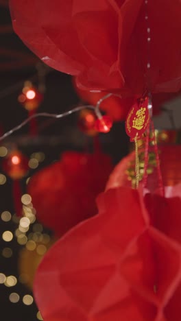 Vertical-Video-Close-Up-Of-Chinese-Symbol-Hanging-From-New-Year-Lantern